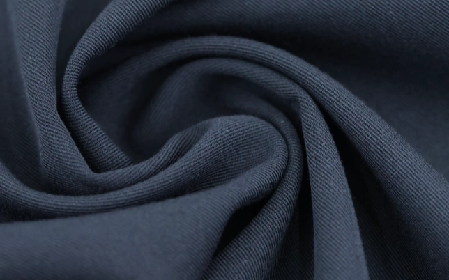 Dark technical fabric showing soft drape and surface texture