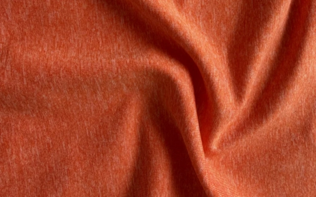 Orange apparel fabric showing texture and drape