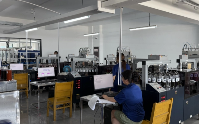 Textile laboratory technician operating fabric testing equipment