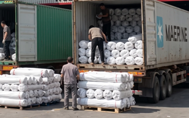 Fabric rolls being loaded for international bulk shipment